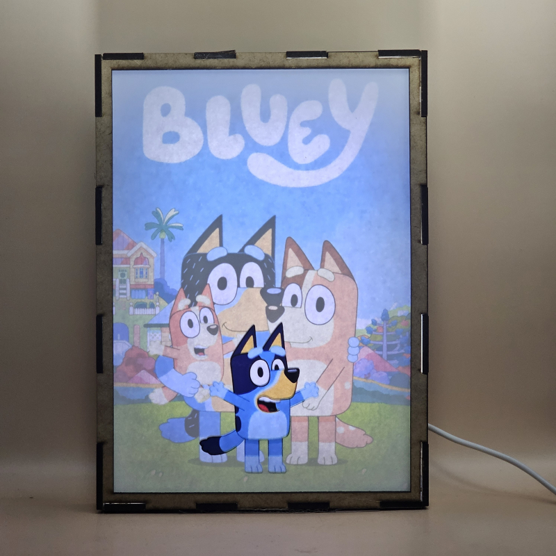 Lámpara ánime  Bluey  con doble imagen del grupo Bluey, Bingo, Chilli y Bandit, vista encendida, con luz ambiente, donde se revela la ilustración completa al encender la luz LED.