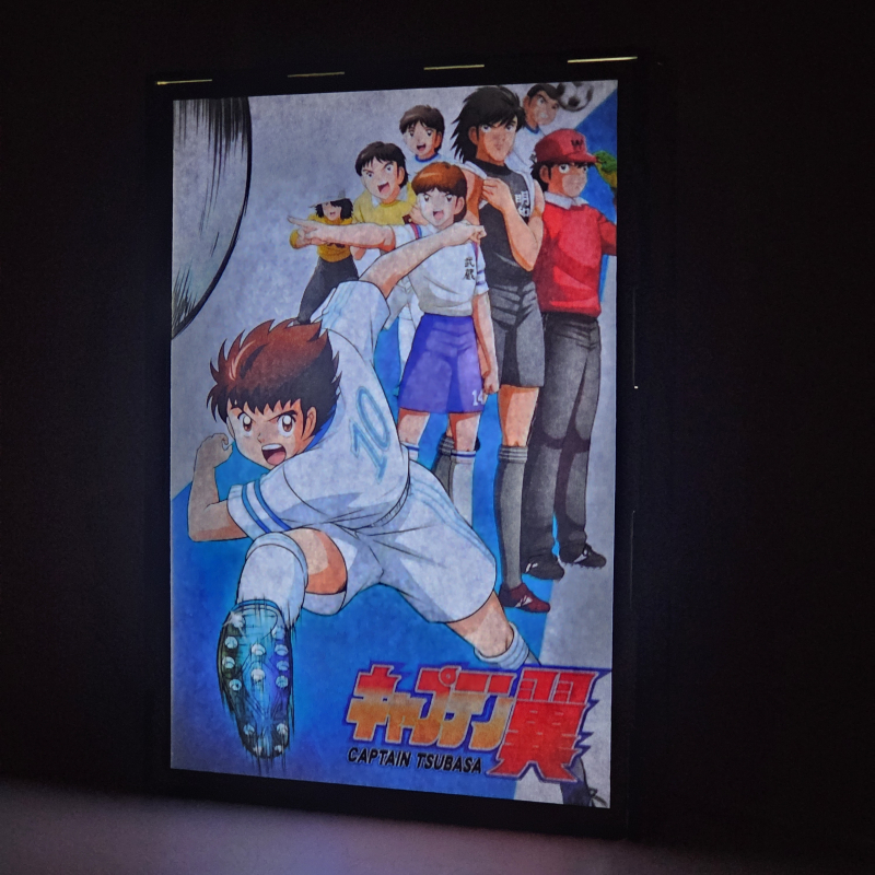Lámpara ánime/manga  Supercampeones  con doble imagen del grupo Oliver Atom, Mark Lenders, Benji Price, Julian Ross, Tom Baker, Bruce Harper y Patty, vista encendida, donde se revela la ilustración completa al encender la luz LED.