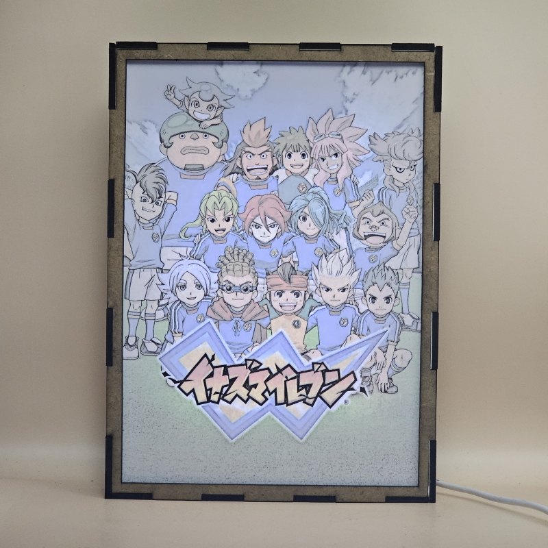 Lámpara ánime/manga  Inazuma Eleven  con doble imagen del grupo Mark Evans, Axel Blaze, Jude Sharp, Nathan Swift, Shawn Frost, Austin Hobbes, Caleb Stonewall, Xavier Foster, Claude Beacons, Bryce Withingale, Archer Hawkins, Thor Stoutberg, Kabeyama Heigorou y Darren LaChance, vista encendida, con luz ambiente, donde se revela la ilustración completa al encender la luz LED.