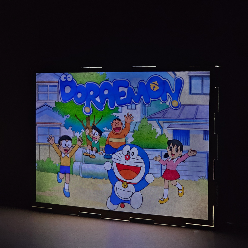Lámpara ánime/manga  Doraemon, el gato cósmico  con doble imagen del grupo Doraemon, Nobita Nobi, Suneo Honekawa, Gigante y Shizuka Minamoto, vista encendida, donde se revela la ilustración completa al encender la luz LED.